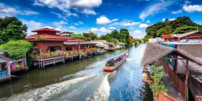 Tourist boat travelling in canal in Bangkok Thailand